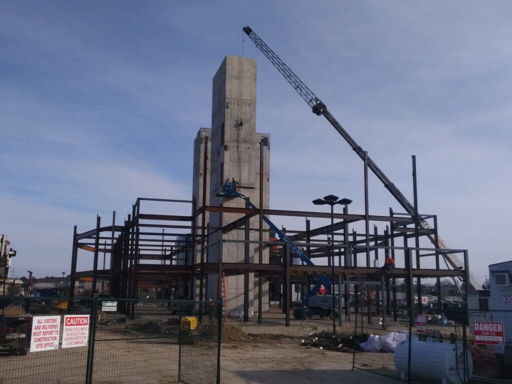 A column with a crane lifting up materials on it