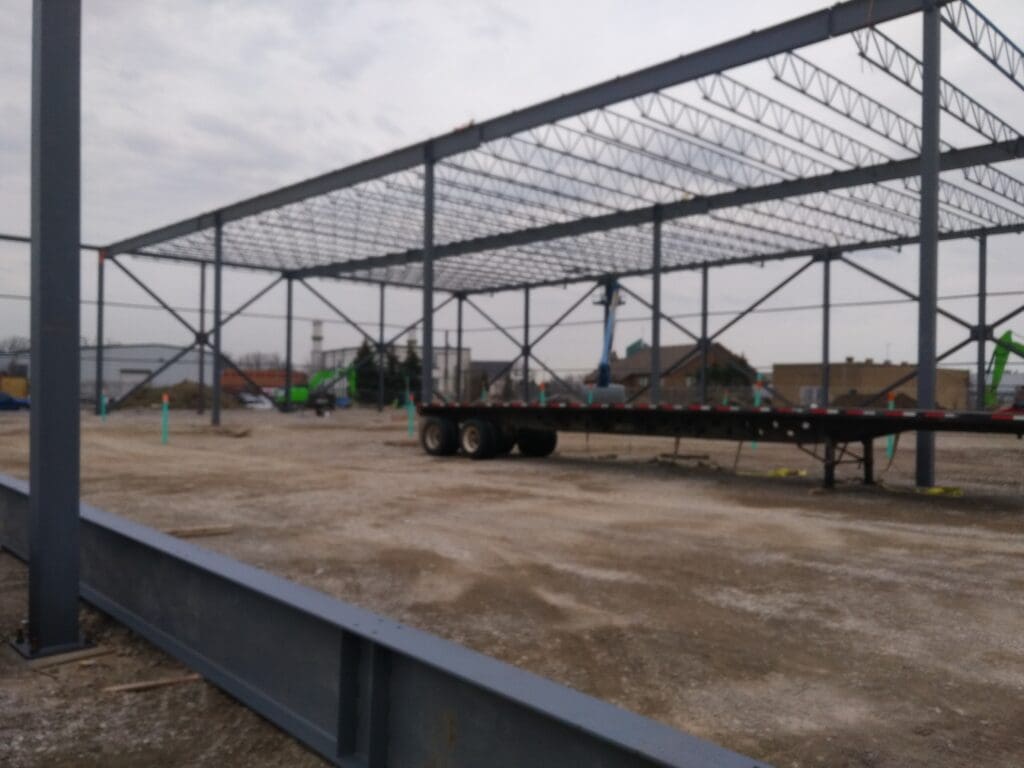 A truck flatbed under a steel roof frame