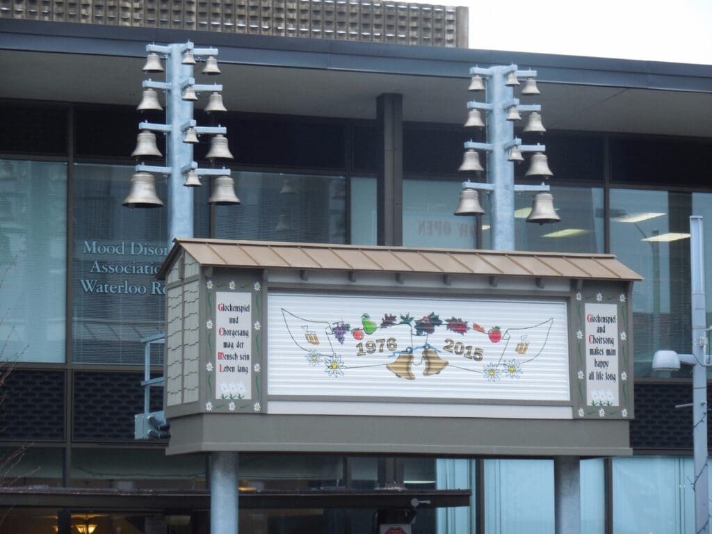 A sign board with bell decor on the top